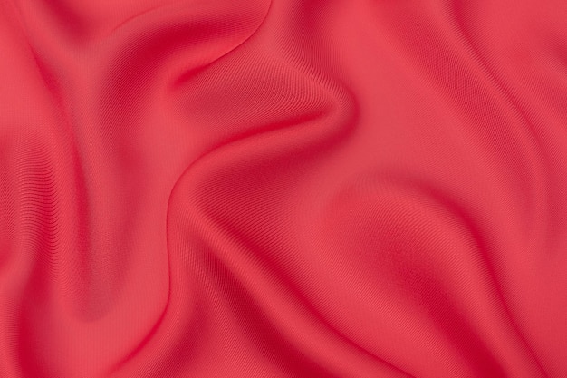 Closeup texture of natural red or pink fabric or cloth in same color Fabric texture of natural cotton silk or wool or linen textile material Red and orange canvas background