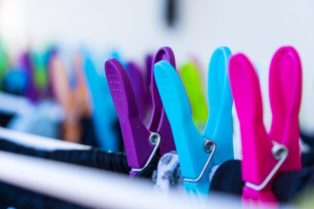 Closeup of three clothespins in the foreground with plenty of copy space concept of hanging clothes and household chores