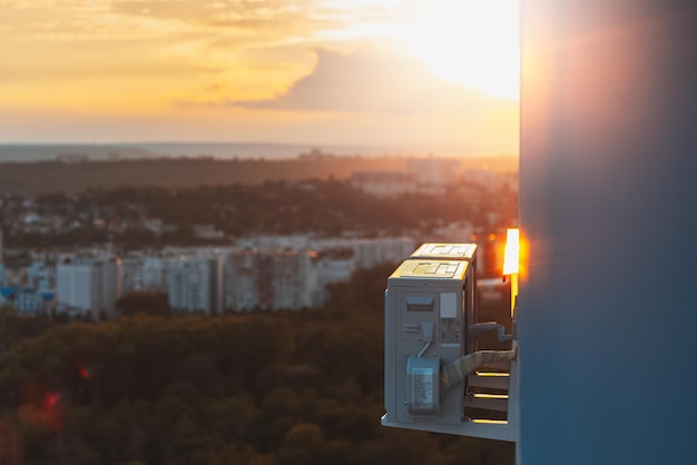 Closeup of two air conditioners exterior compressor fixed on facade on background of beautiful sunset