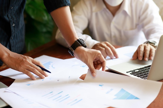 Closeup of two business people meeting to analyze and plan investment marketing financial report data on the table in office Project meeting concept