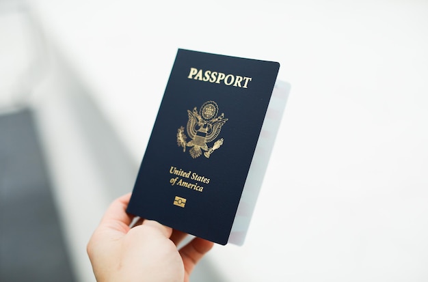 Closeup of a US passport with immigration visa citizenship and travel paperwork on a wooden tabl