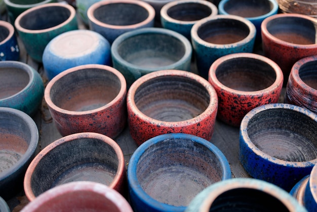 Closeup of used empty ceramic flower pots in greenhouse or hothouse plant pots for planting