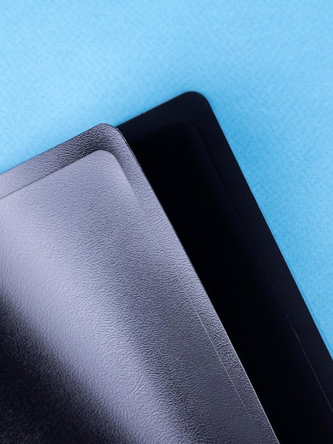 Closeup view of black plastic document folder on office table