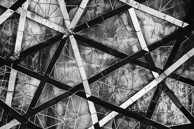 A closeup view of a black and white wall with a geometric pattern of interconnected lines and shapes A geometric pattern of interconnected lines and shapes