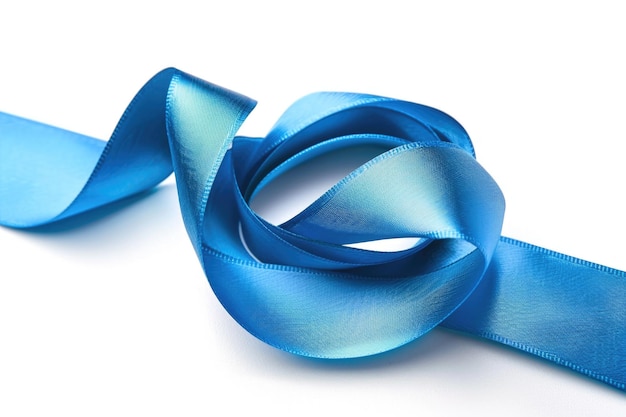 A closeup view of a blue ribbon on a white surface