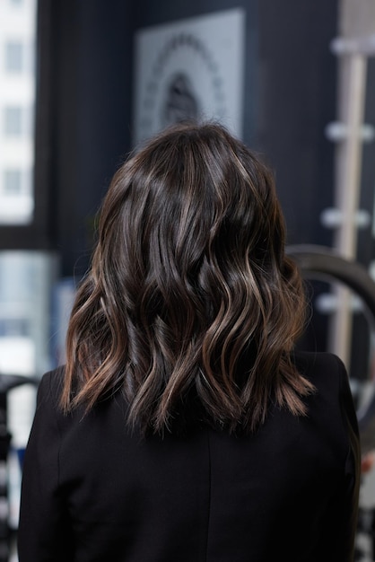 A closeup view of a bunch of shiny curls brown hair