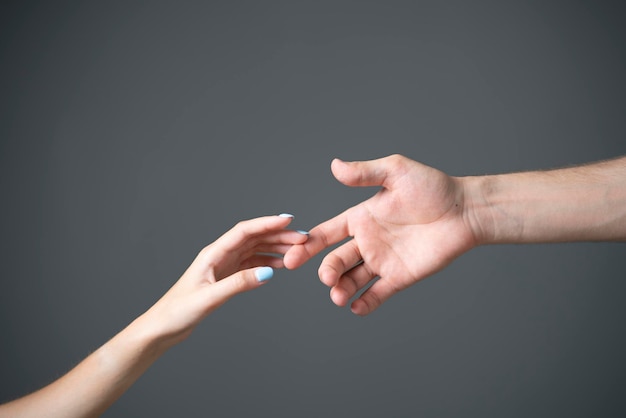 A closeup view captures the tender touch between a mans and a womans hand