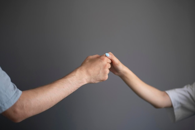 A closeup view captures the tender touch between a mans and a womans hand