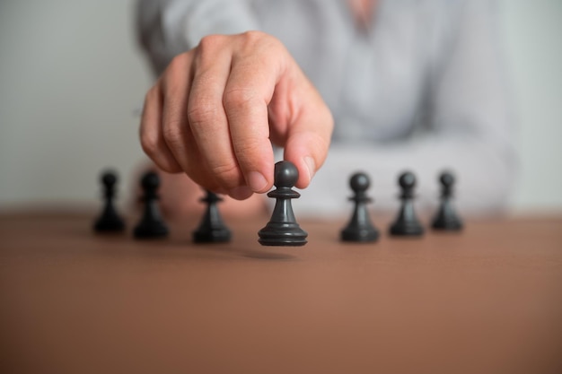 Closeup view of caucasian male hand moving a pawn chess piece