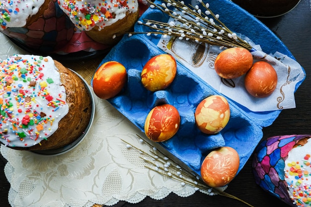 Closeup view of chicken eggs homemade easter cake and willow twigs