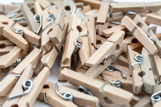 Closeup view of many wooden clothespins scattered on the table