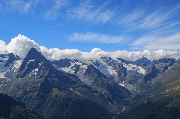 Closeup view mountains scenes in national park Dombai, Caucasus, Russia, Europe. Summer landscape, sunshine weather, dramatic blue sky and sunny day