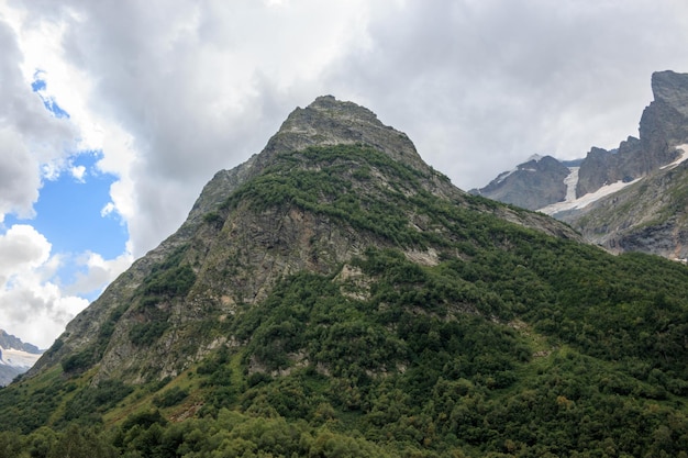 Closeup view mountains scenes in national park Dombai, Caucasus, Russia, Europe. Summer landscape, sunshine weather, dramatic blue sky and sunny day