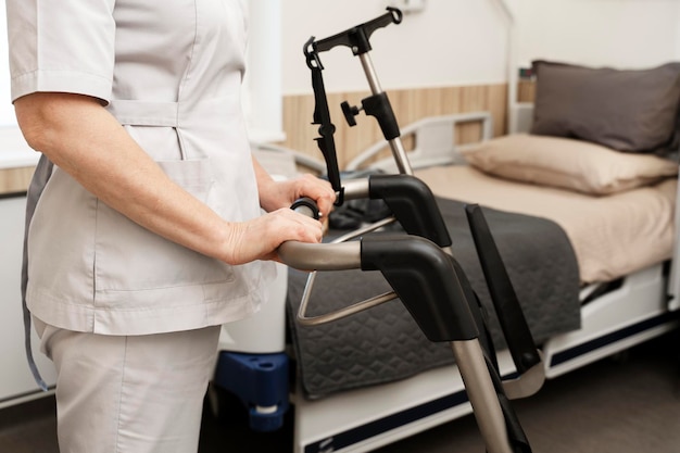 Closeup view of nurse and wheelchair in hospital ward In the ward there is a hospital bed comfortable and tidy