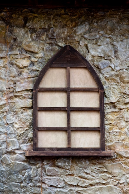 Photo closeup view of an old medieval wooden window.