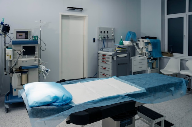 Closeup view of the operating table in the operating room Equipped ward with important tools and equipment Concept of professional treatment professional surgery