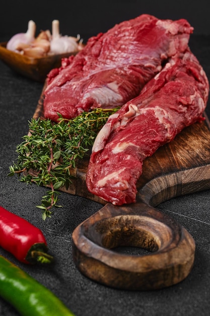 Closeup view of raw beef whole tenderloin on black background