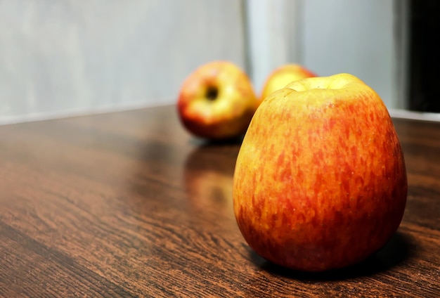 Closeup view of ripe red apples on wooden background