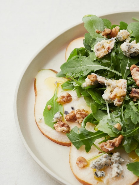 Closeup view of rocket pear blue cheese and walnut salad