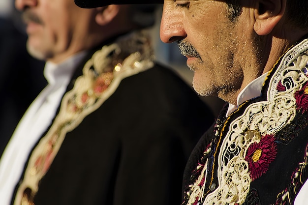 A closeup view of Spanish men wearing traditional clothing in a vibrant outdoor setting