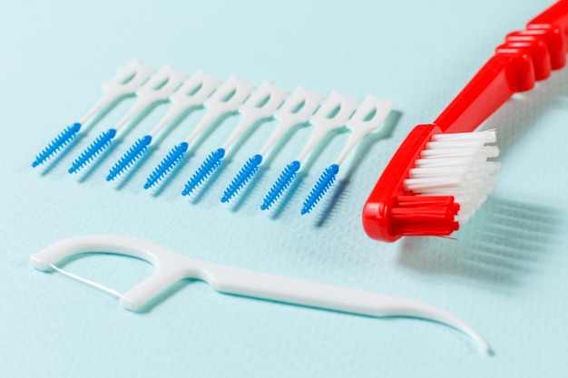 Closeup view of a toothbrush a silicone flossing toothpick and interdental toothpick brushes