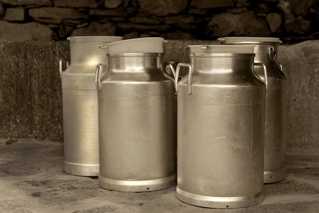 Closeup on vintage metal milk cans in a farm agriculture concept