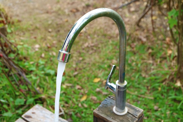 Closeup of water running from the faucet in the garden