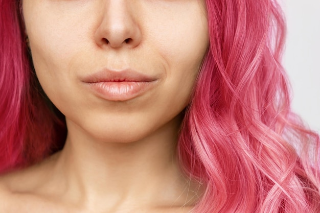 Closeup of wavy deep pink hair of a young woman isolated on a white background Result of coloring