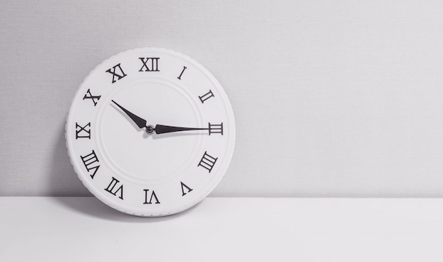 Closeup white clock for decorate show a quarter past ten o'clock