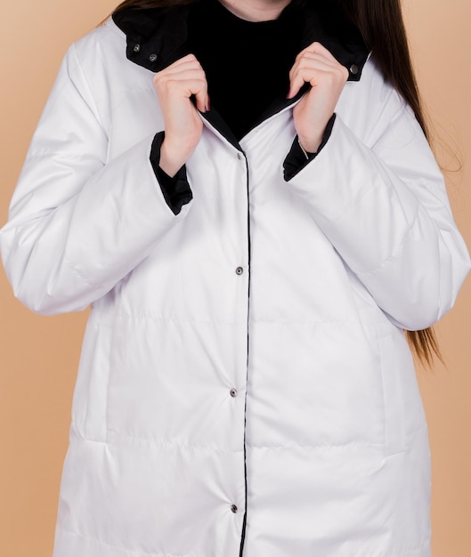 CloseUp of White Coat Collar Peach Background