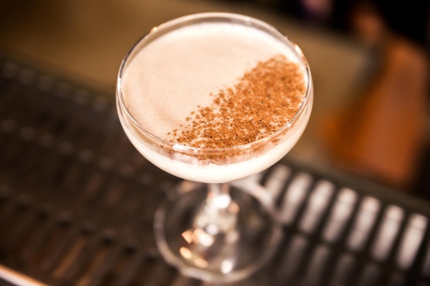 Closeup of a white colored cocktail garnished with cinnamon Horizontal photo