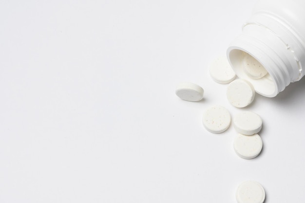 Closeup white medicine pills on white background