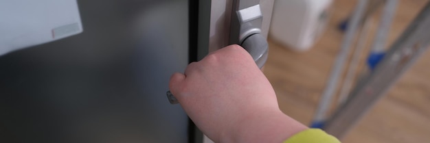 Closeup of woman hand holding and pushing doorknob bedroom interior design detail with modern