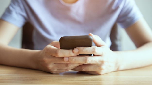 Closeup woman hand holding smart phone