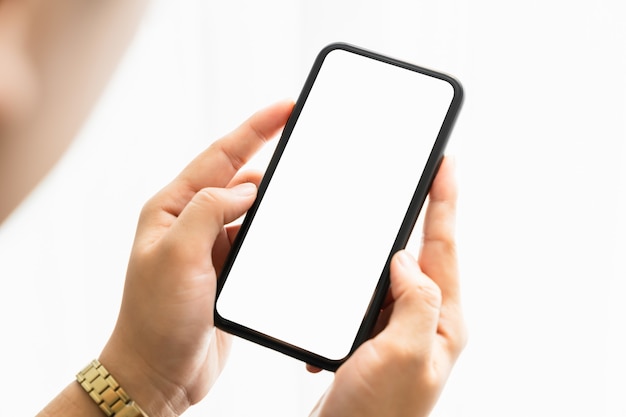 Closeup of woman hand holding smartphone and the screen is blank, social network concept.