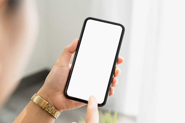 Closeup of woman hand holding smartphone and the screen is blank, social network concept.