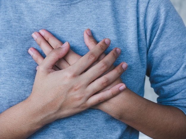 Closeup woman holding breast , woman having heart attack