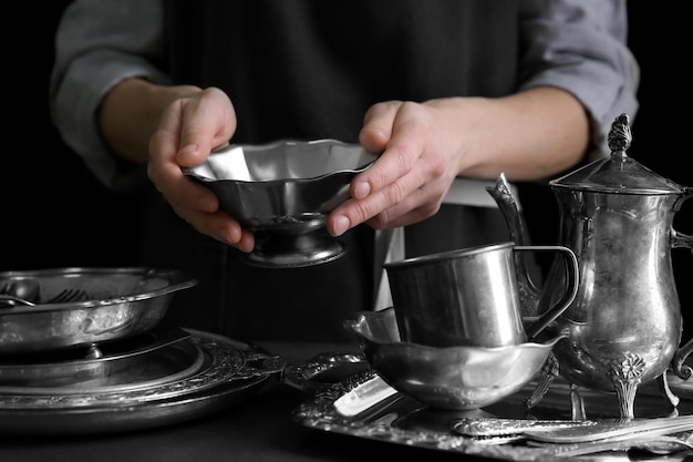 Closeup of woman holding silver bowl