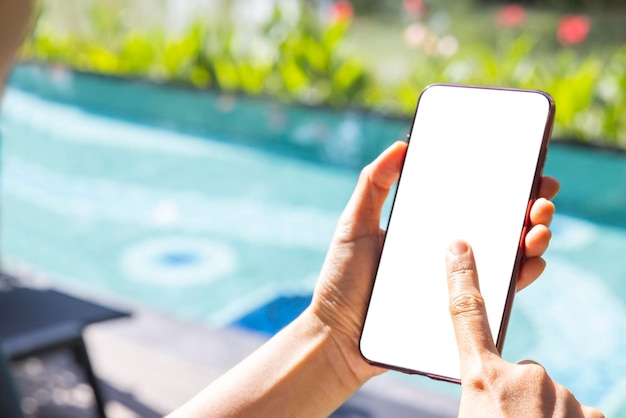 Closeup woman of Left hand held right hand use finger touches with digital smartphone white screen isolated on white background Concept of technology connection communication social