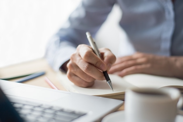 Closeup of Woman Making Notes in Office