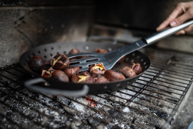 Closeup of a woman mixing chestnuts roasting