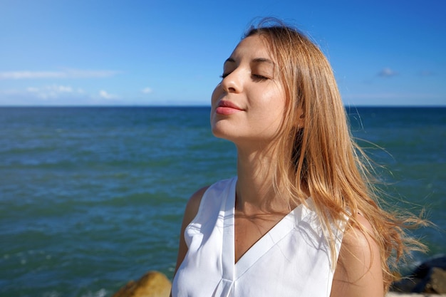 Closeup woman relaxing breathing fresh air on sea