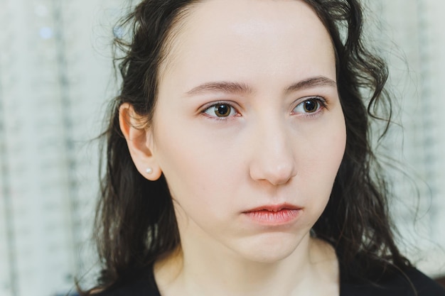 Closeup of a woman's face with dilated pupils after ophthalmic treatment