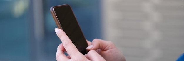 Closeup of woman surfing internet on smartphone or typing message female using modern gadget