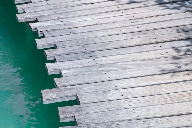 Closeup of a wooden bridge over the sea