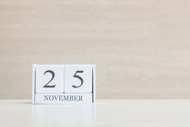 Closeup wooden calendar with black 25 november word on wood desk