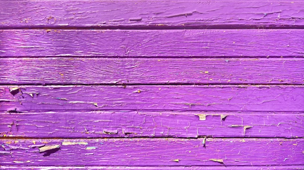 Closeup of a wooden surface painted purple under the lights perfect for textures and backgrounds