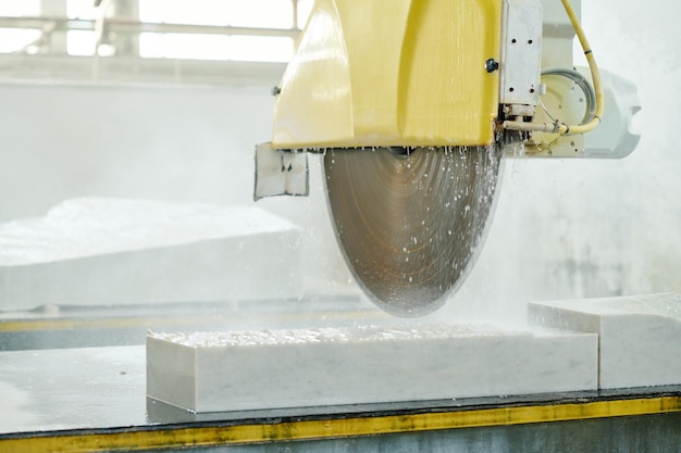 Closeup of work of lathe for cutting marble in factory of cutting stones