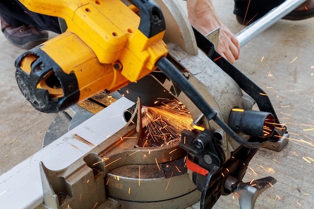 Closeup of worker cutting metal with grinder Sparks while grinding iron Low depth focus