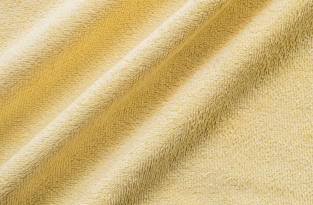 Closeup wrinkled yellow napkin fabric background